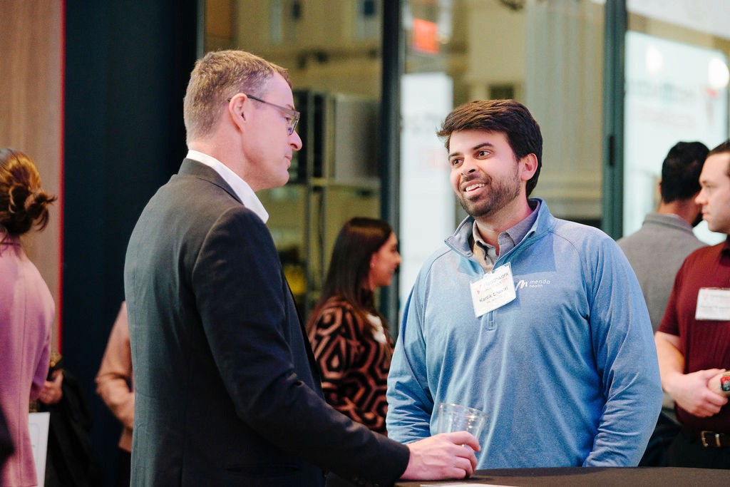 Two attendees in conversation at a Healthworx networking event