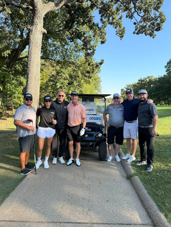 ODS participants and guests beside a golf cart at the 2025 charity tournament