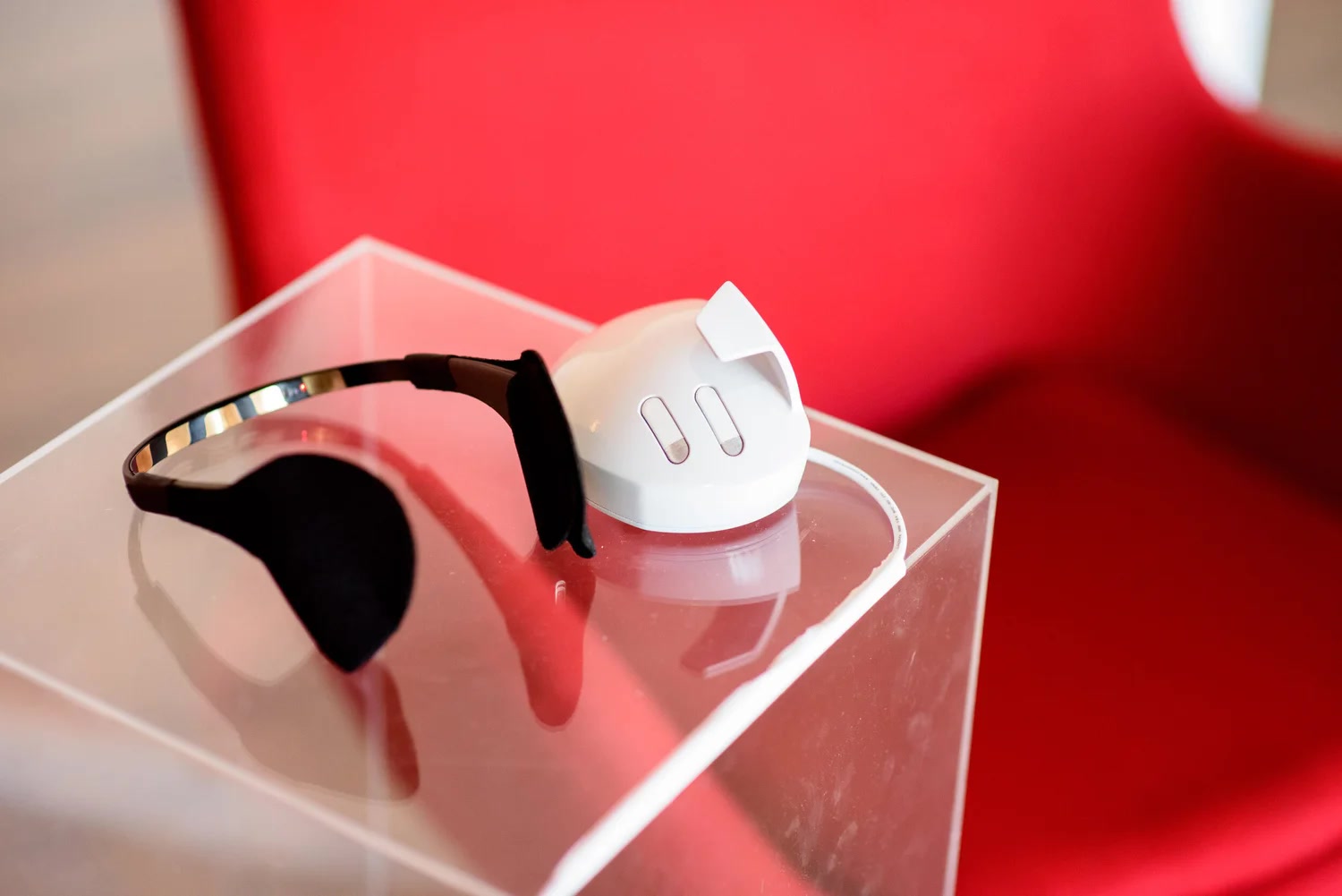 A black sensor headband and white input device from the Cigna data-visualization campaign displayed against a red background