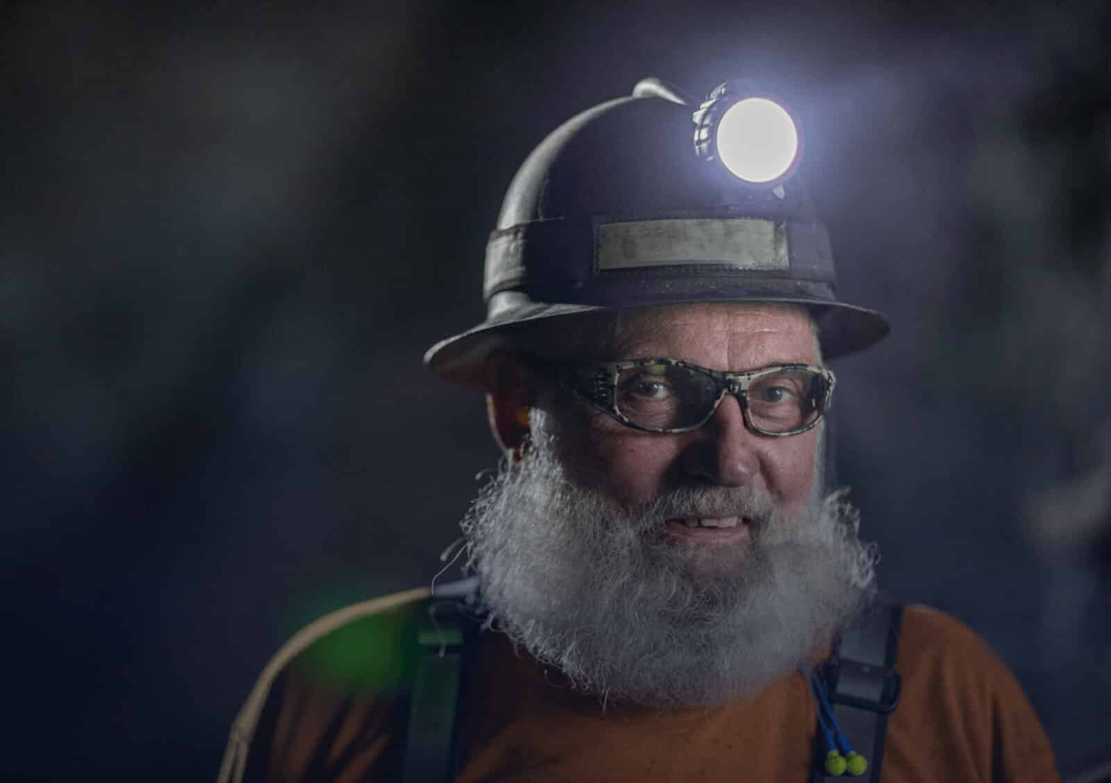 A miner wearing an illuminated hard hat in a company-published Hecla photograph