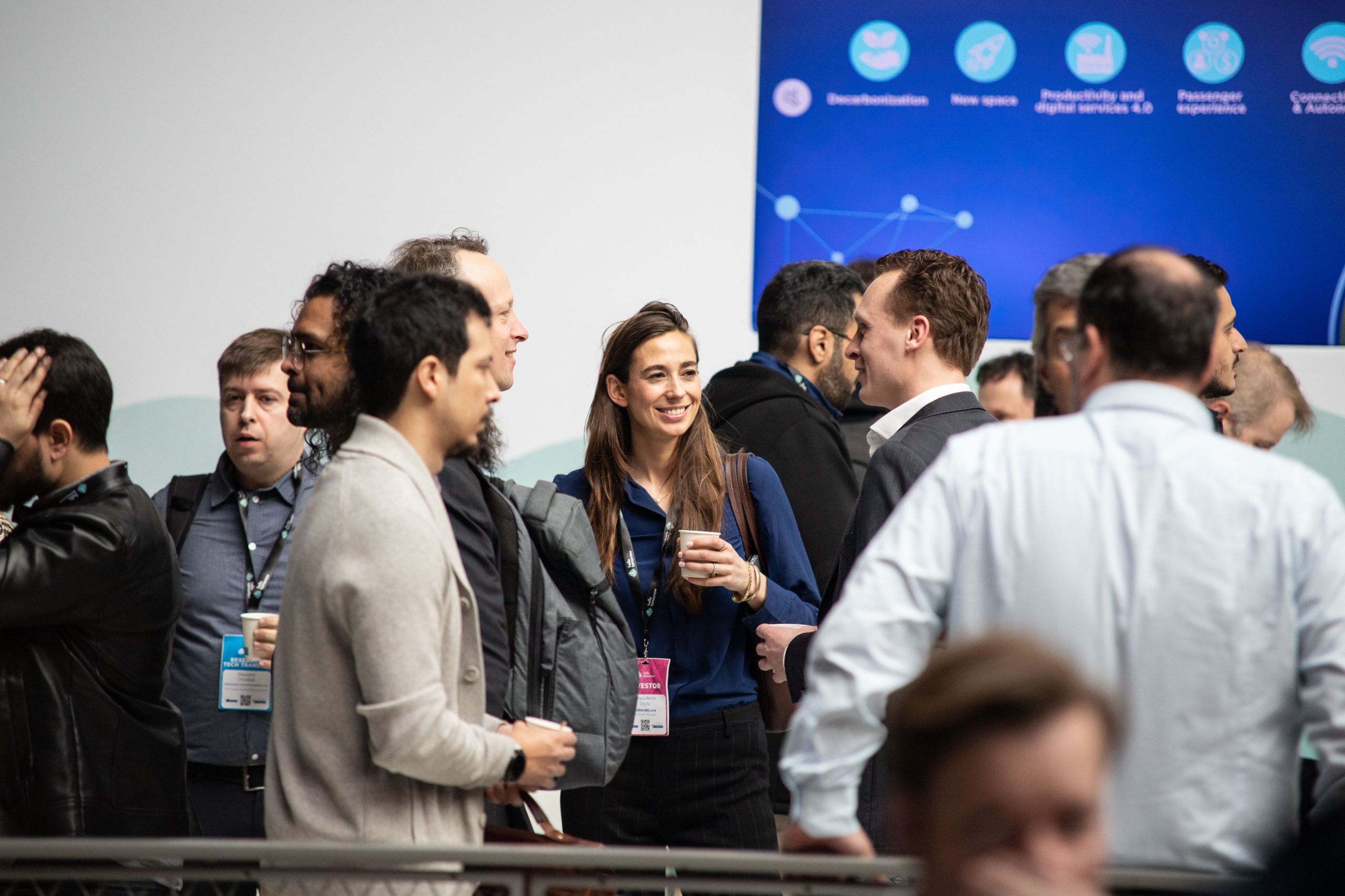 Attendees talking in small groups at a Hello Tomorrow Summit