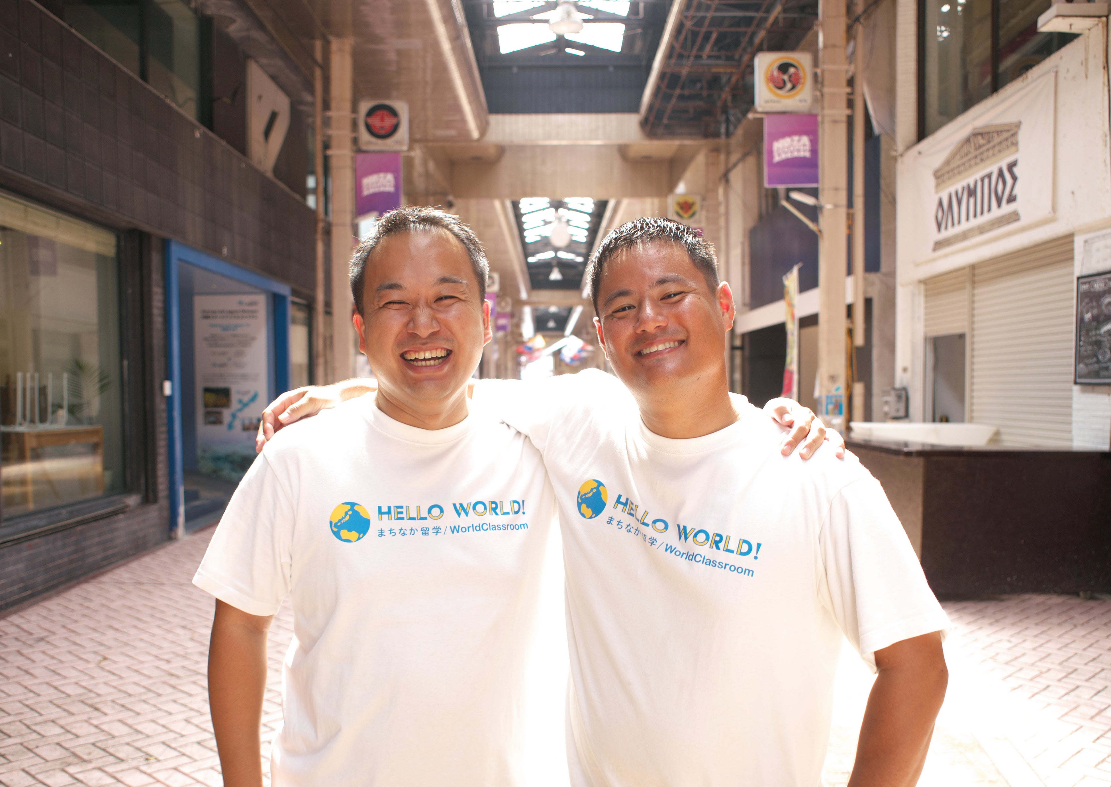 HelloWorld’s two co-founders standing together in an Okinawa shopping arcade