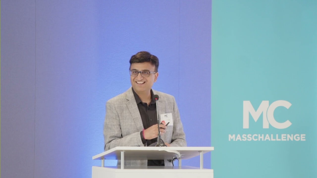 Hemant Madaan speaking at a lectern during a MassChallenge event