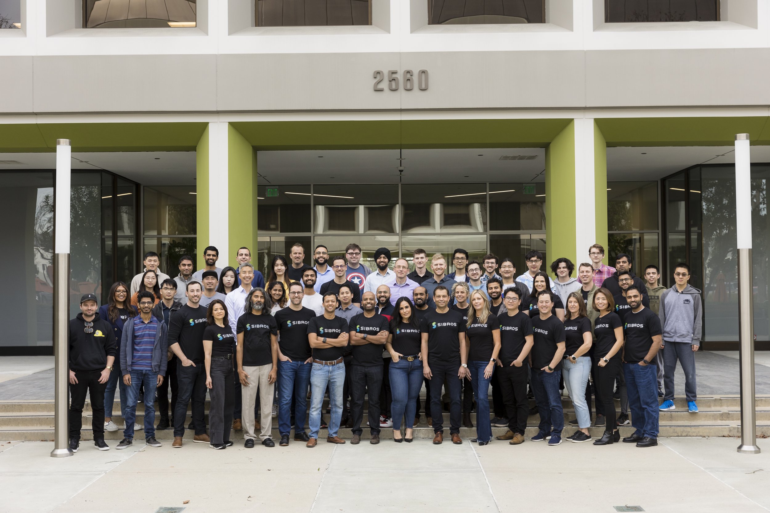 Sibros colleagues standing together outside an office building