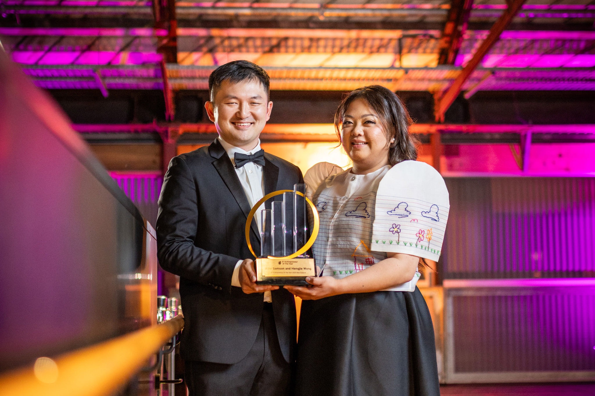 Hengjie Wang and Alliv Samson holding their joint 2025 EY Entrepreneur of the Year trophy