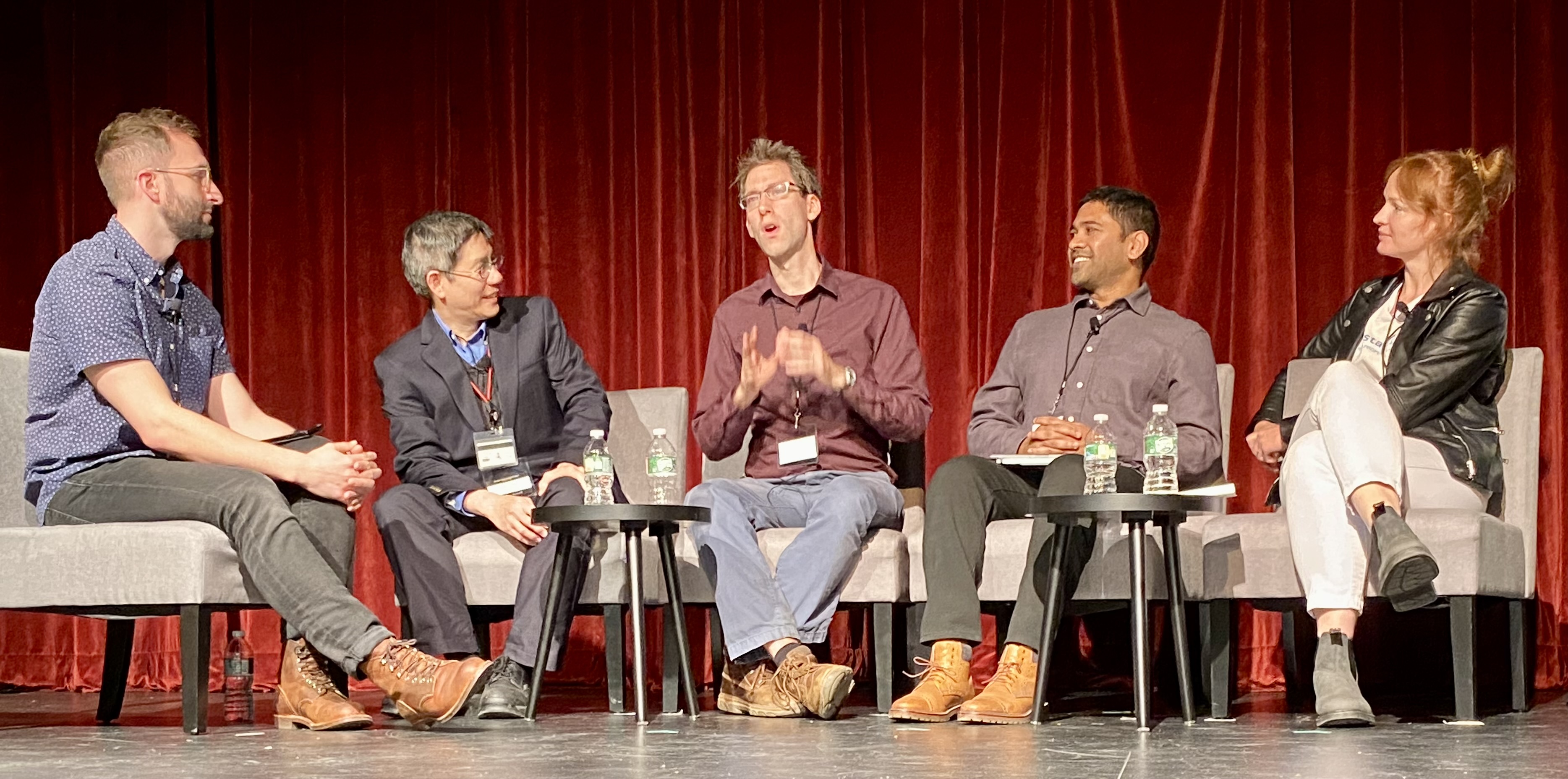 Henriette Fleischmann, seated at right, joins researchers onstage at MIT’s 2022 Convergence conference.