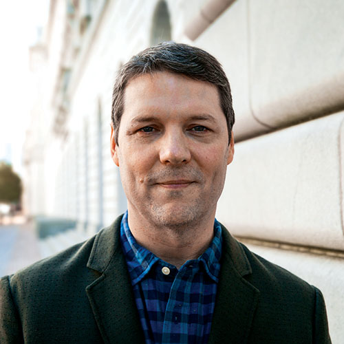 Henry Chassaignac outdoors in a dark jacket and blue checked shirt