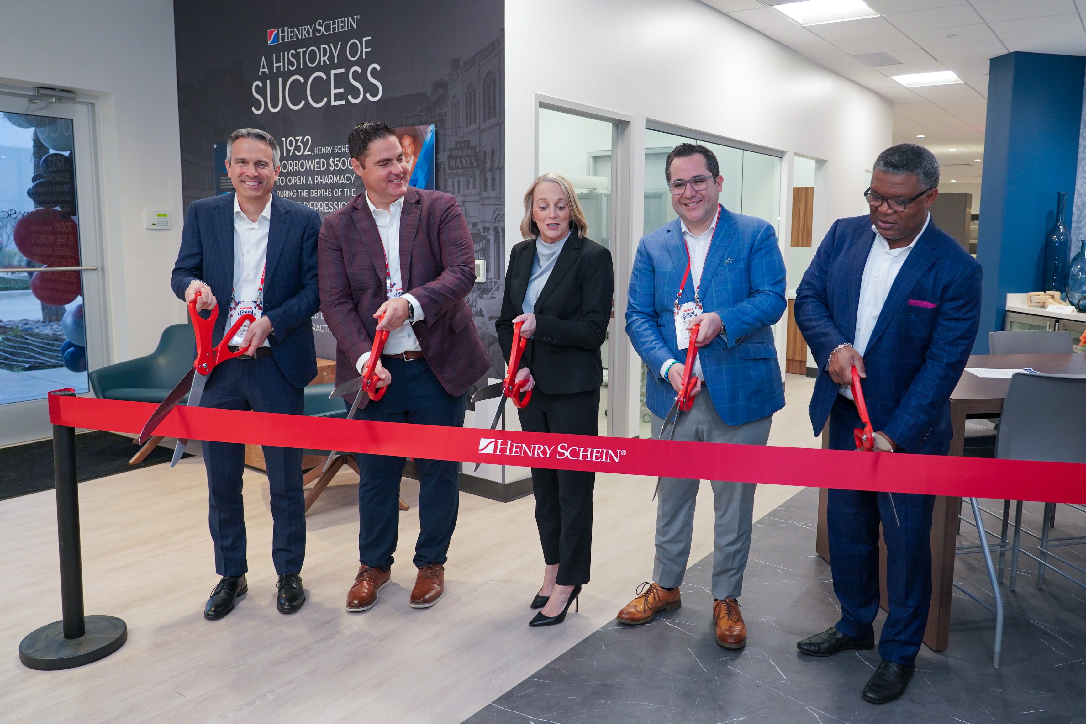 Henry Schein leaders cut a red ribbon at the Dallas Discovery Center opening