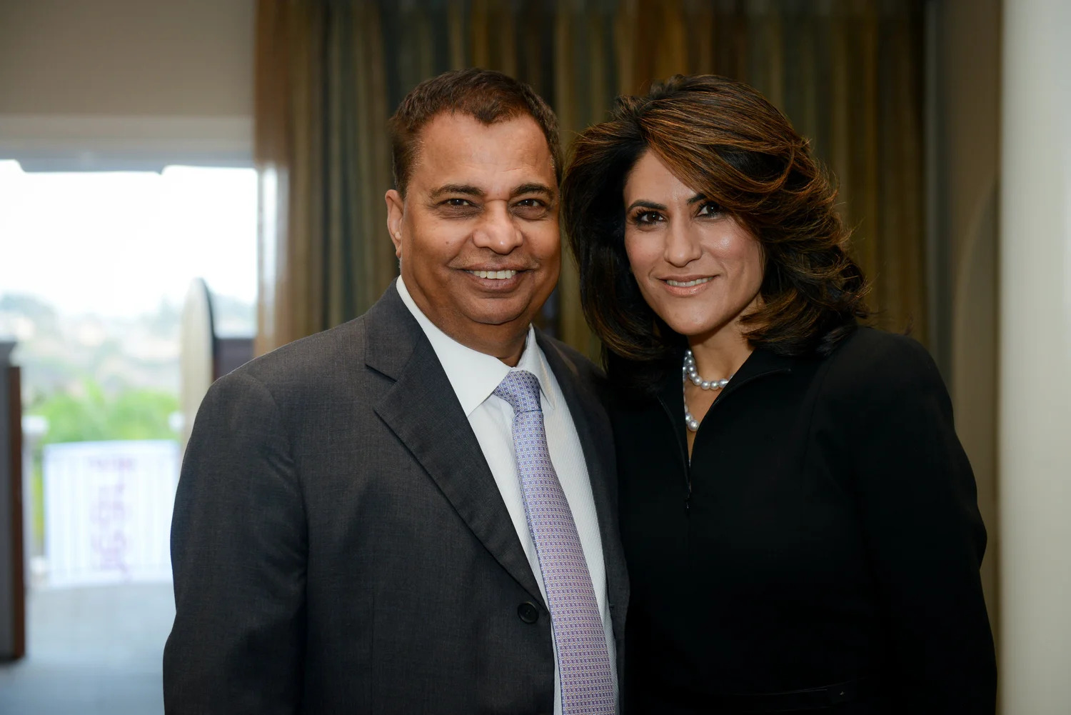 Hersh and Shalu Saluja smiling together at a Heart to Heart anniversary event