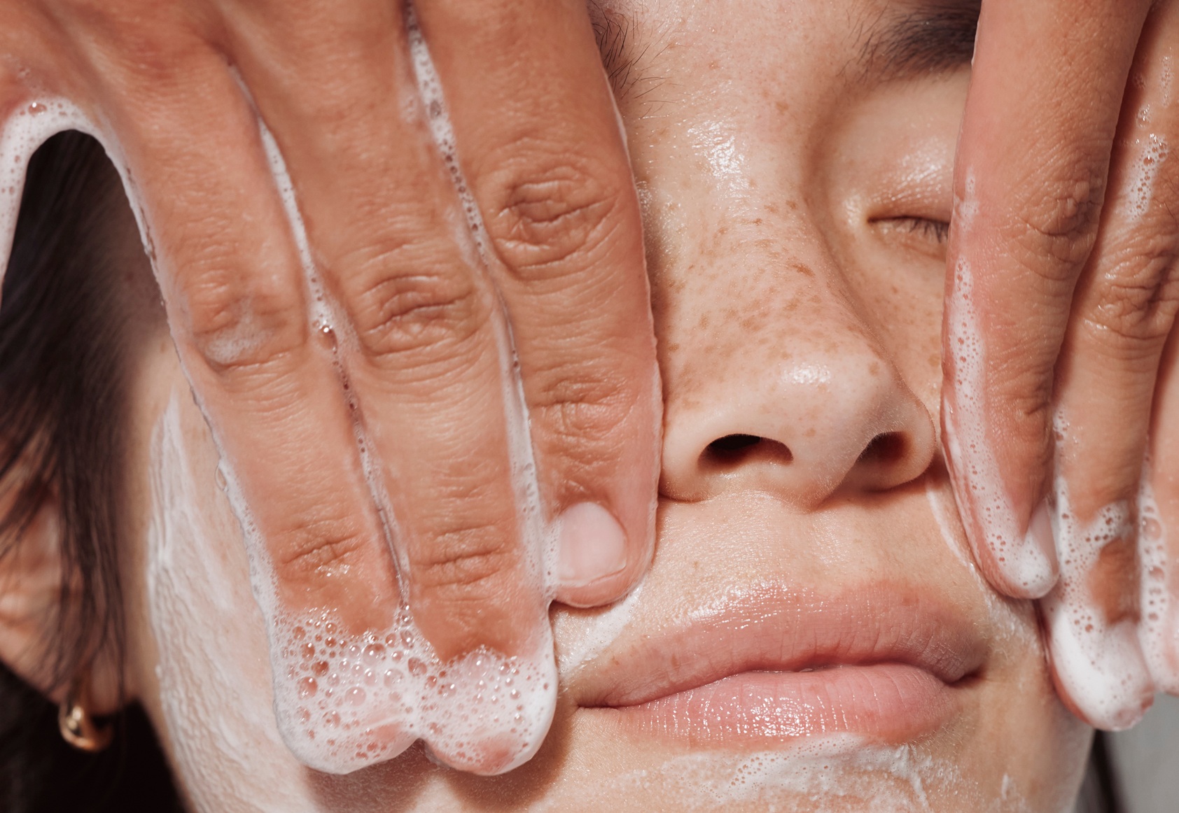 Heyday esthetician cleansing a client's face during treatment