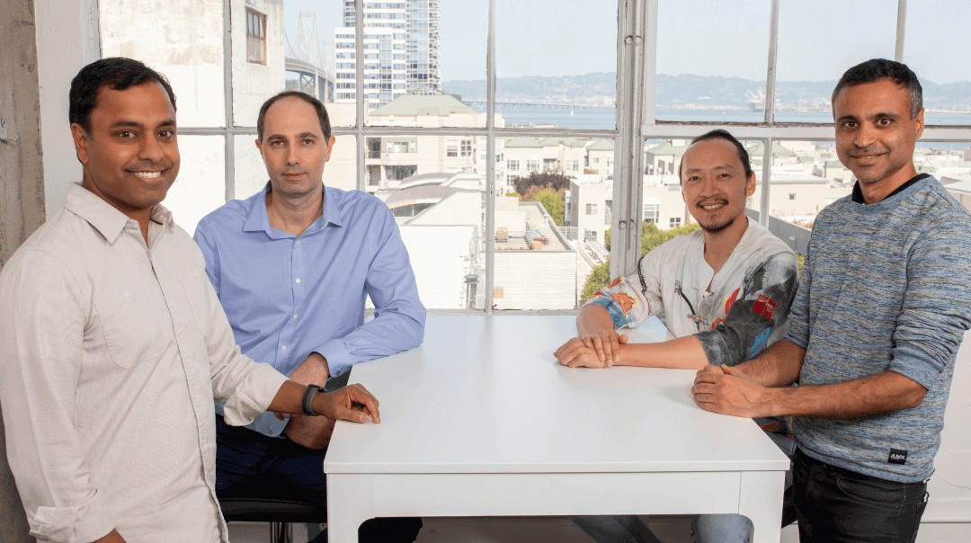 Four members of Heymarket's early team seated together in an office