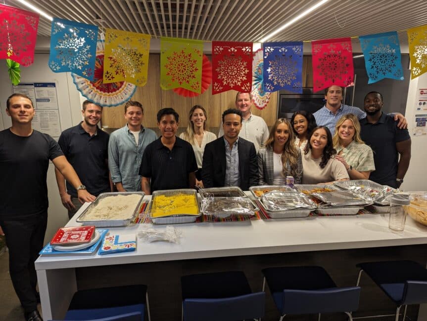 HHAeXchange employees in New York gathered around food during a Hispanic Heritage Month celebration.