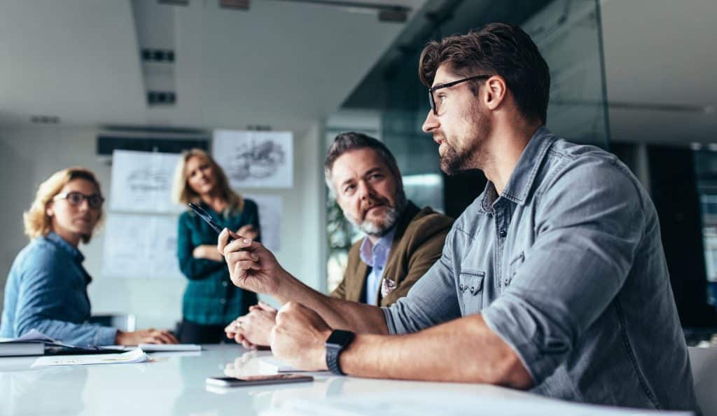 Four colleagues in a business meeting, an image used in High Road's public website library