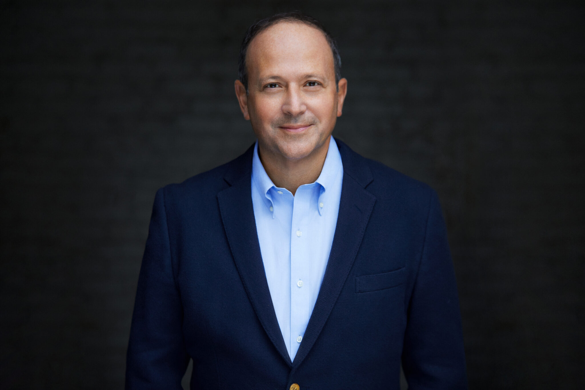 Matthew Hiltzik, founder and CEO of Hiltzik Strategies, in a navy jacket against a dark background
