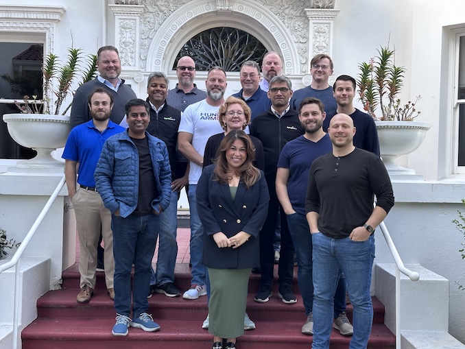Himanshu Shukla standing with members of the Lightbeam sales team on outdoor steps