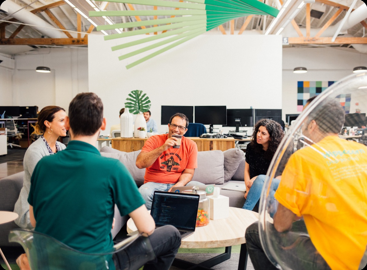 Hippo employees gathered around a meeting table in an office