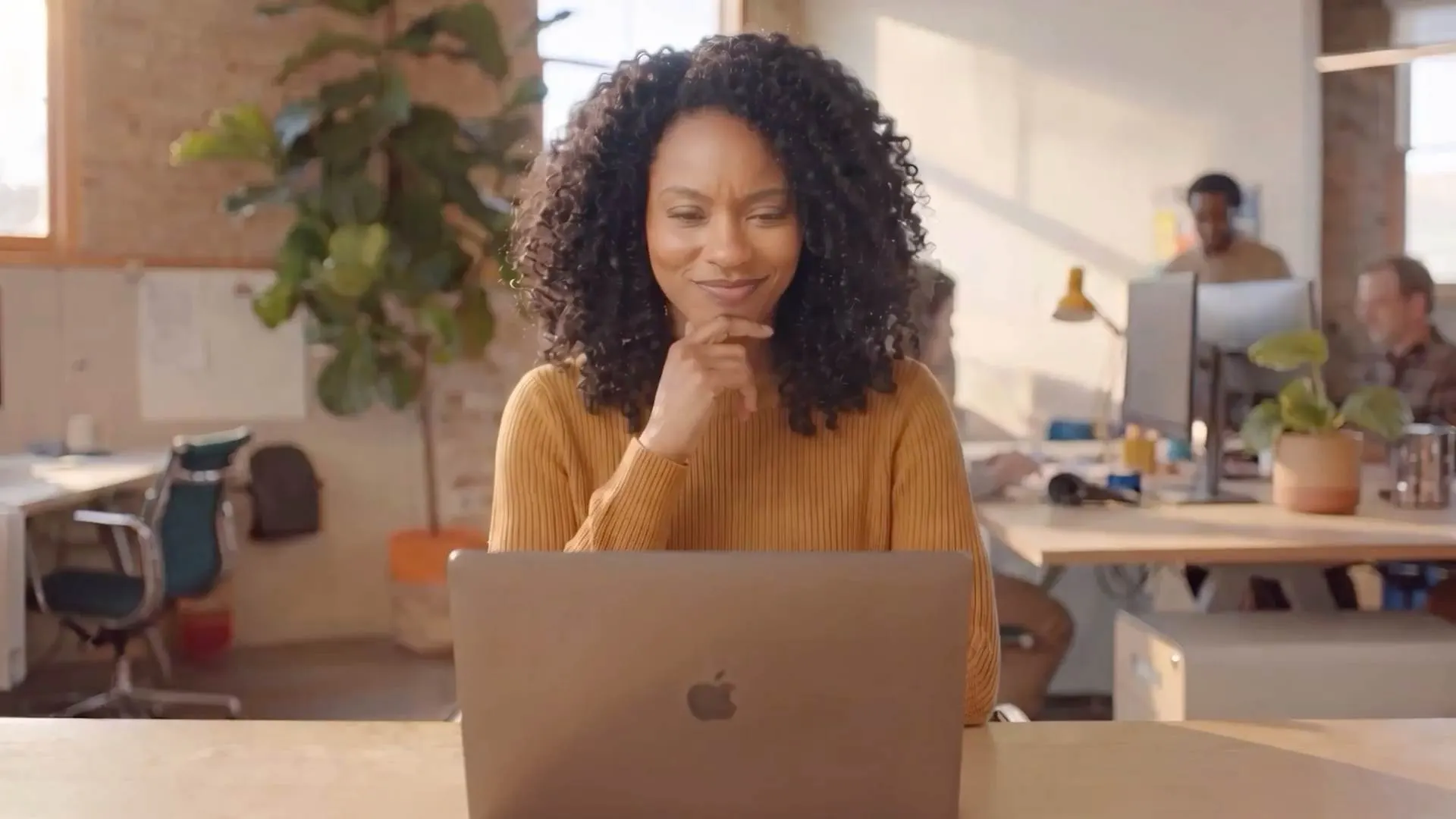 Recruiter working at a laptop in hireEZ's agent-native product campaign