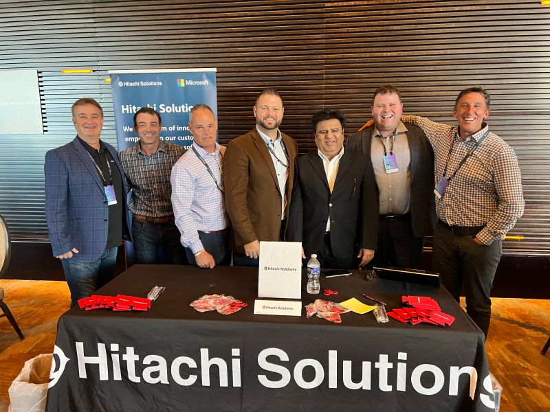 Seven Hitachi Solutions team members at a Microsoft partner event in Dallas