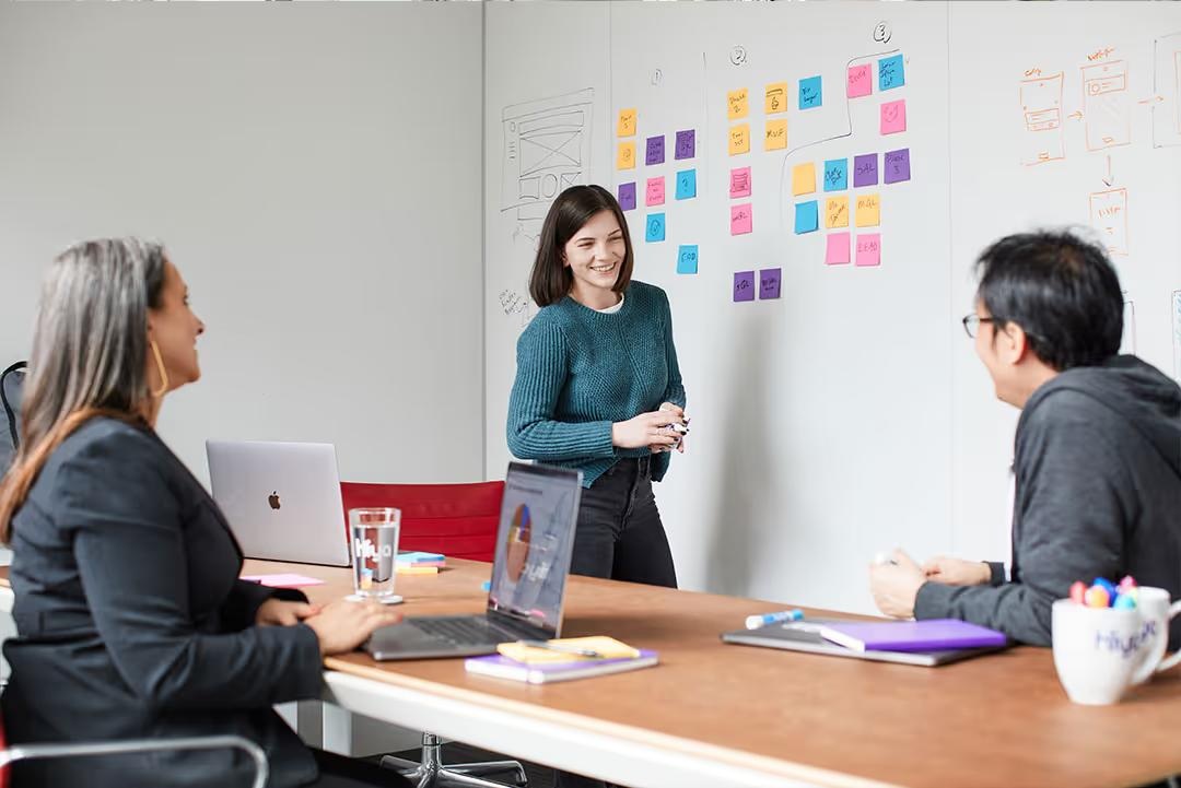 Hiya office meeting room with a long table and colorful wall art