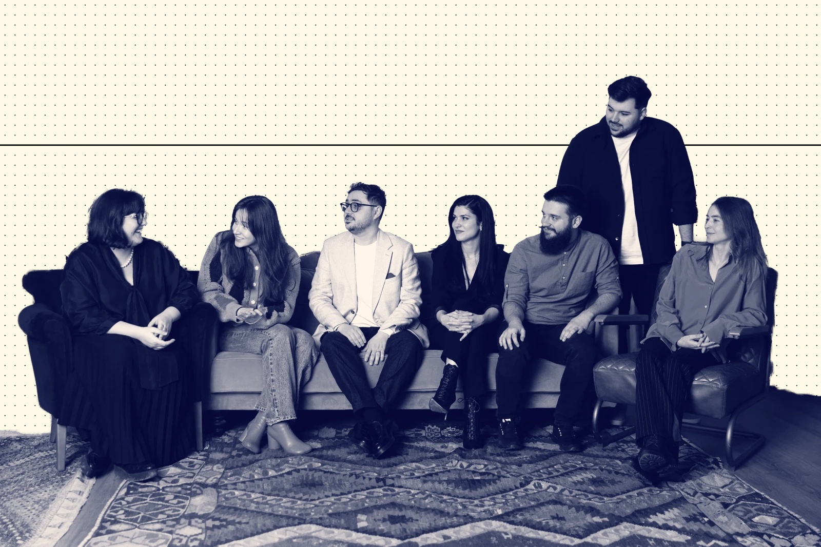 Members of the HKR.TEAM team seated together in an official company photo composition
