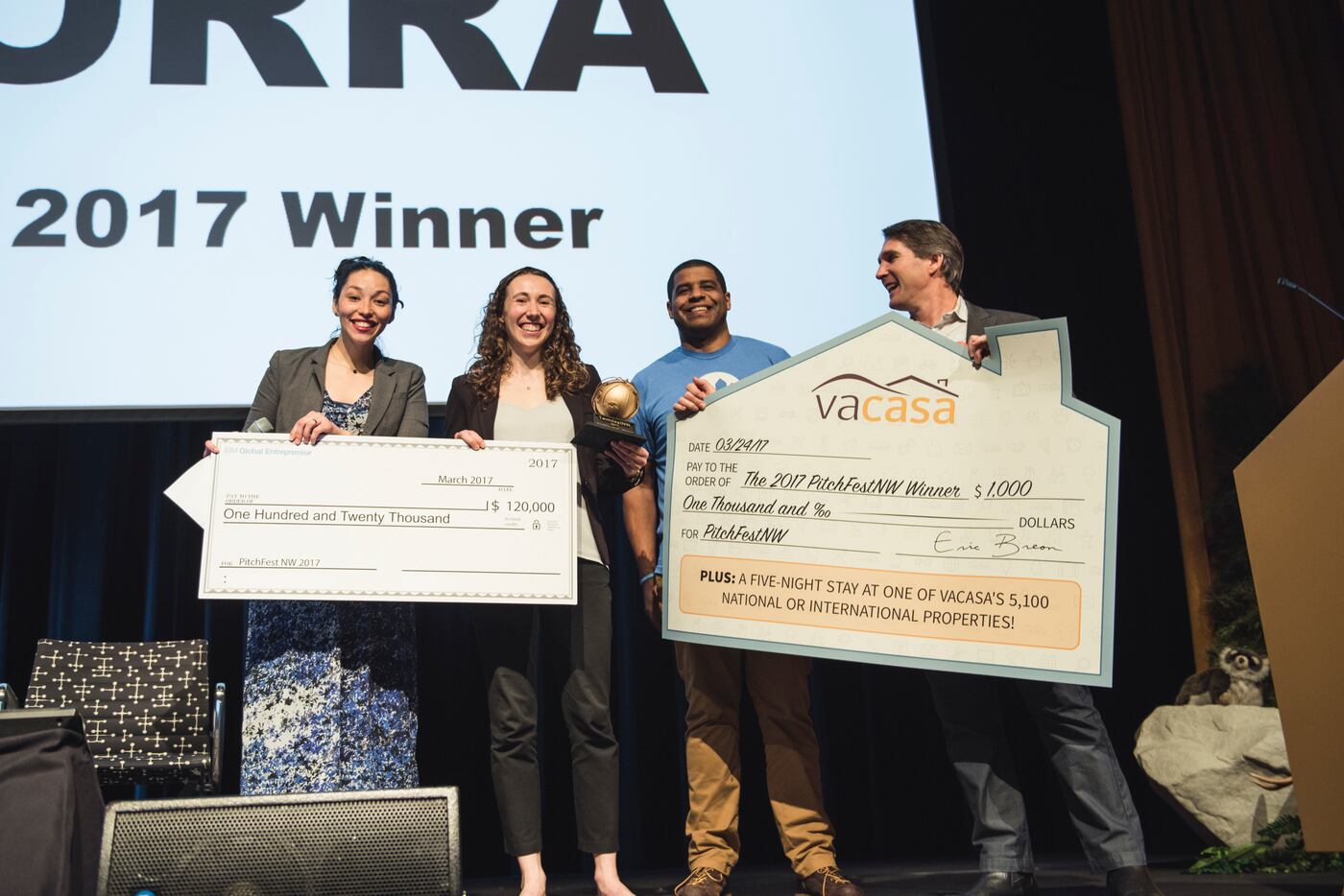 Holly Rockweiler, center left, smiling onstage with the 2017 PitchFestNW award group