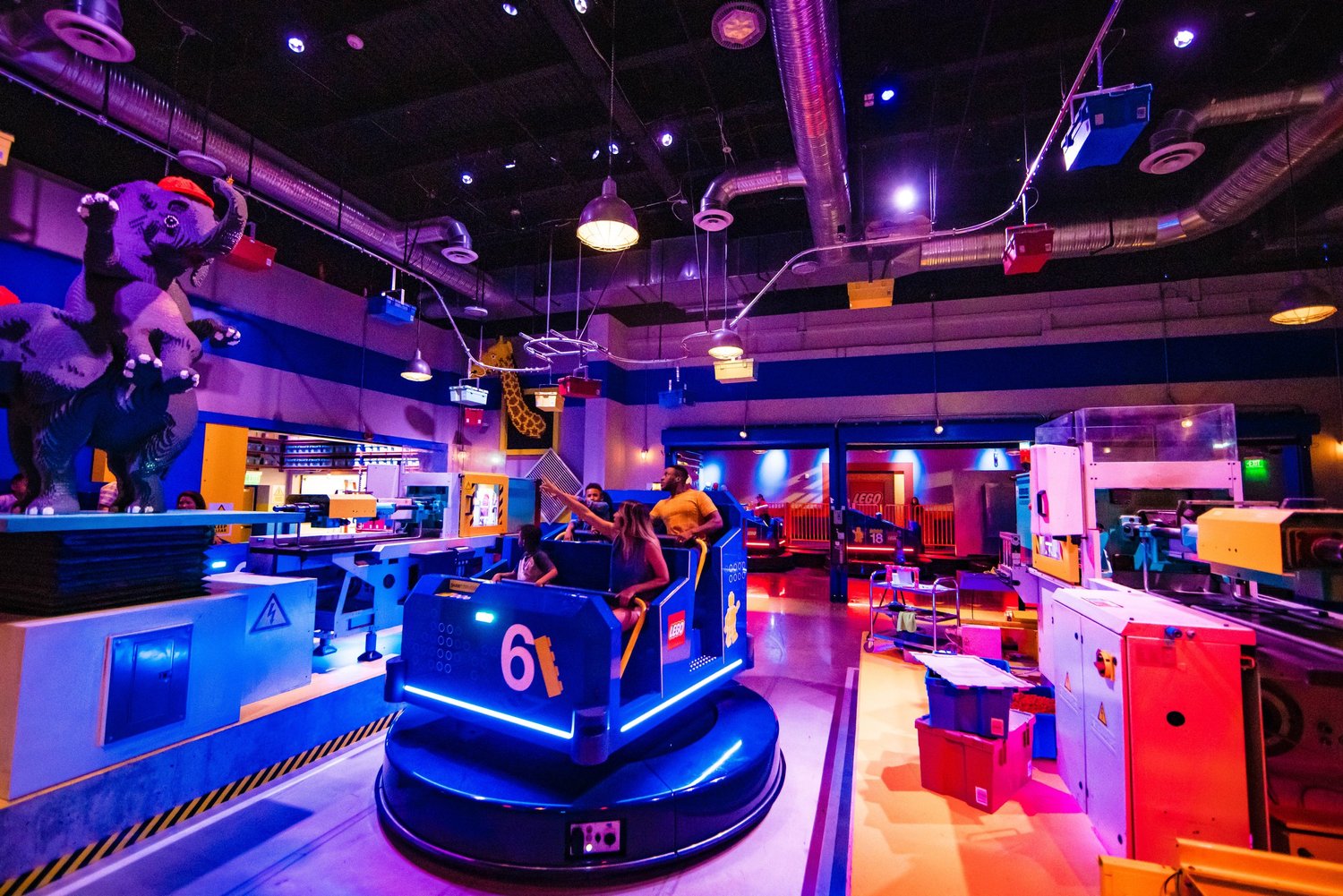 Riders passing through the colorful LEGO Factory Adventure Ride