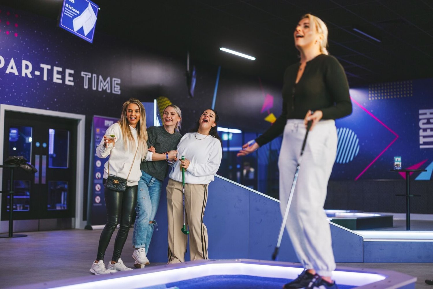 Four women playing a technology-enhanced 360Golf course