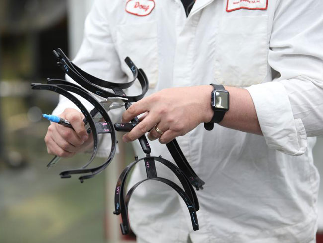 A Honda associate handles molded face-shield frames