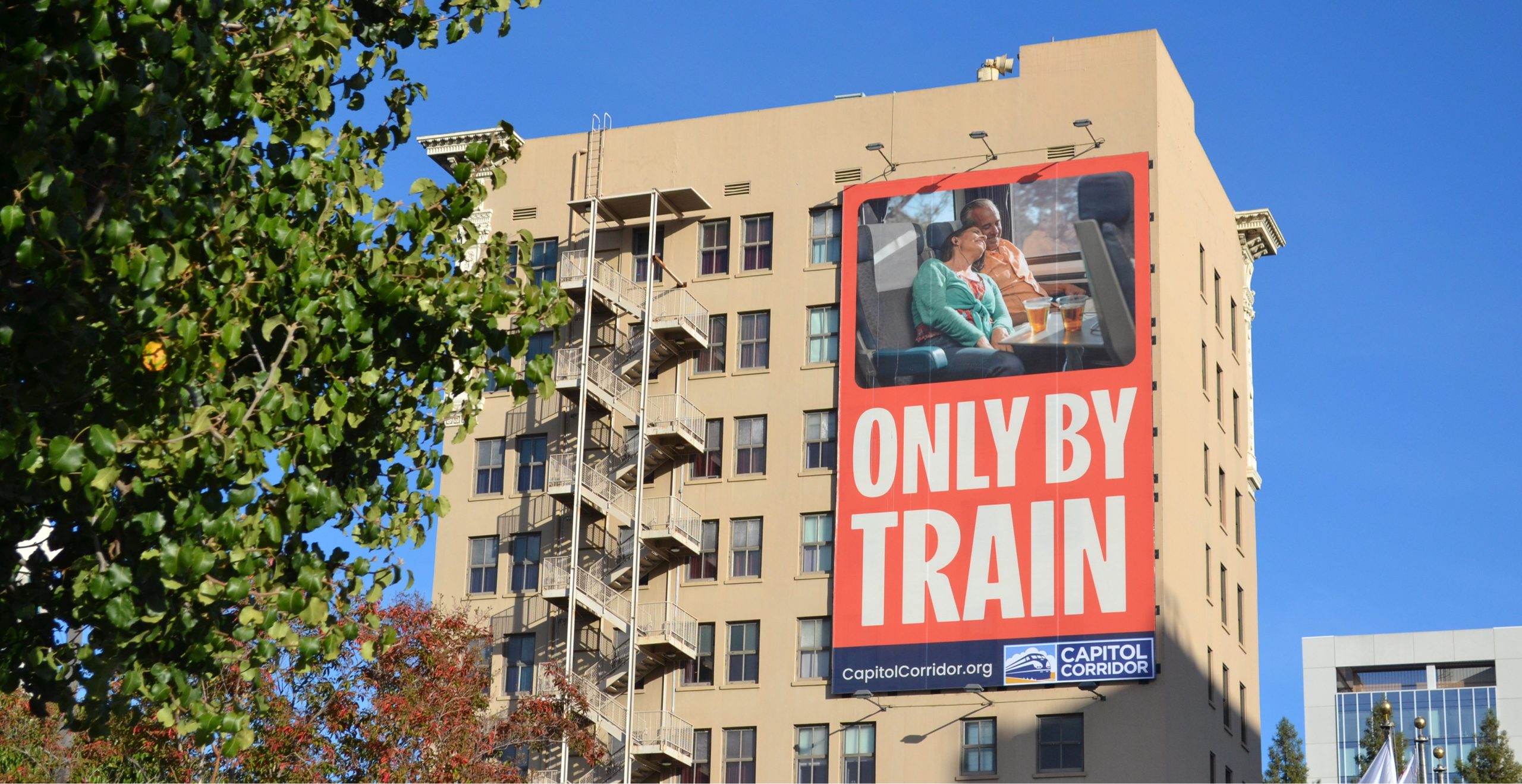 Capitol Corridor Only By Train campaign displayed on a Sacramento billboard