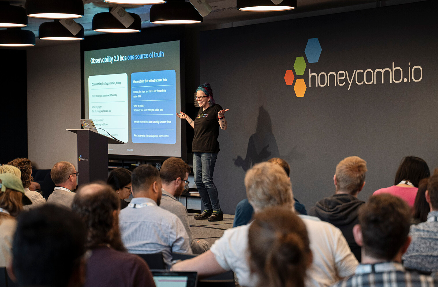 Honeycomb co-founder Charity Majors presenting an Observability 2.0 comparison to an audience