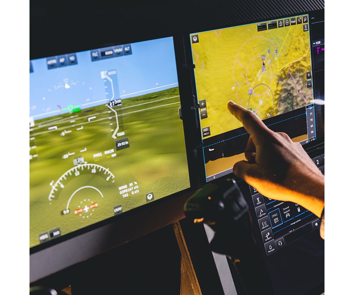 A hand using the navigation display on Honeywell’s Anthem integrated flight deck