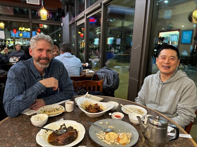 Two ForteBio veterans seated at a restaurant table in Hong Tan’s dinner photograph