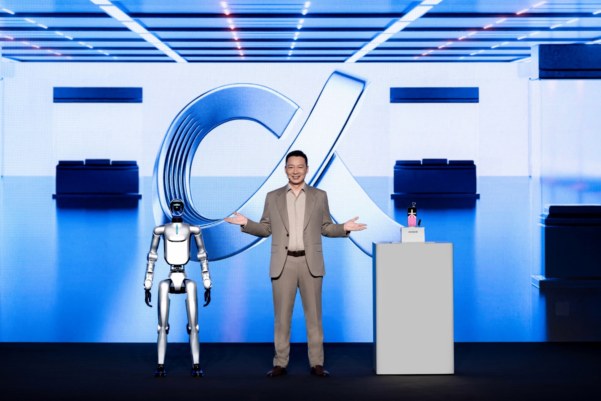 HONOR CEO James Li onstage beside a humanoid robot and Robot Phone concept at MWC 2026