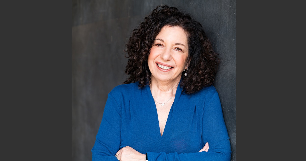 Hope Neiman wearing blue against a dark gray background