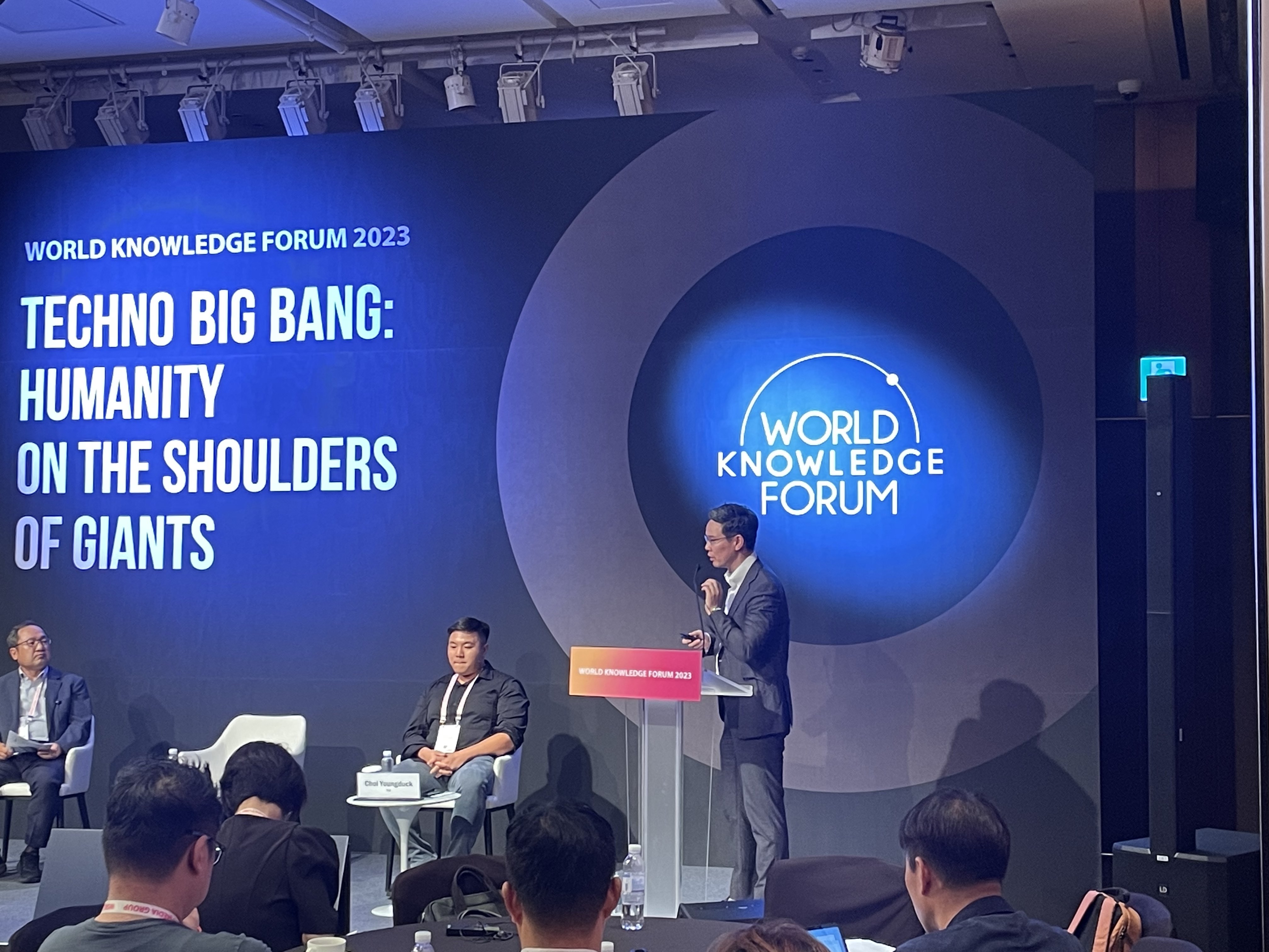 Hoshik Shin speaking at a lectern at the World Knowledge Forum 2023
