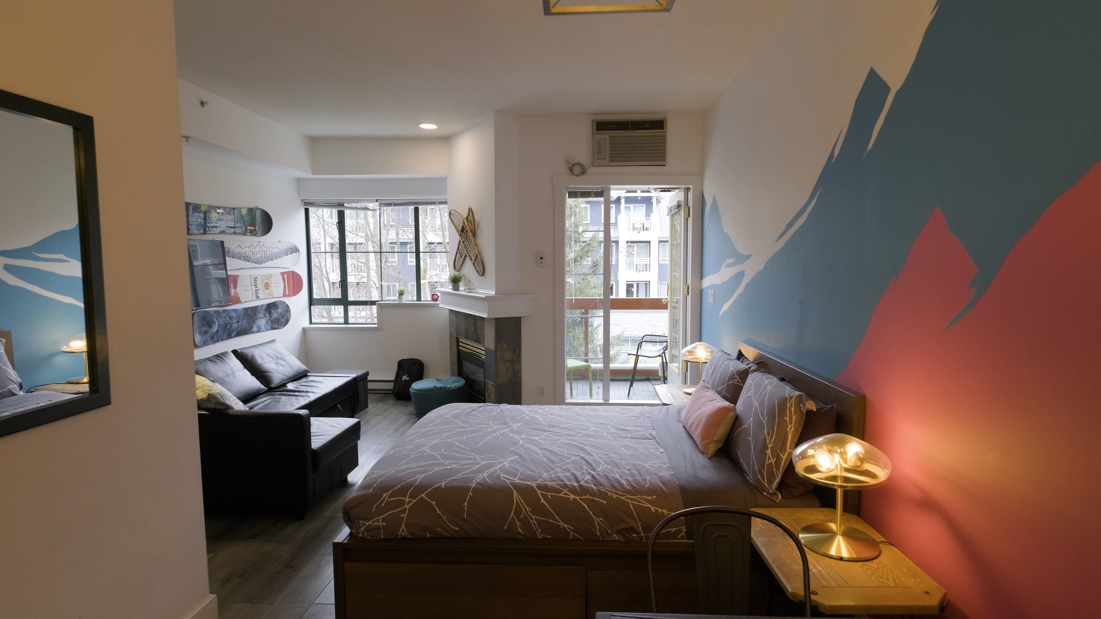 Lifty Life’s Whistler studio with a mountain mural, snowboard wall display and balcony