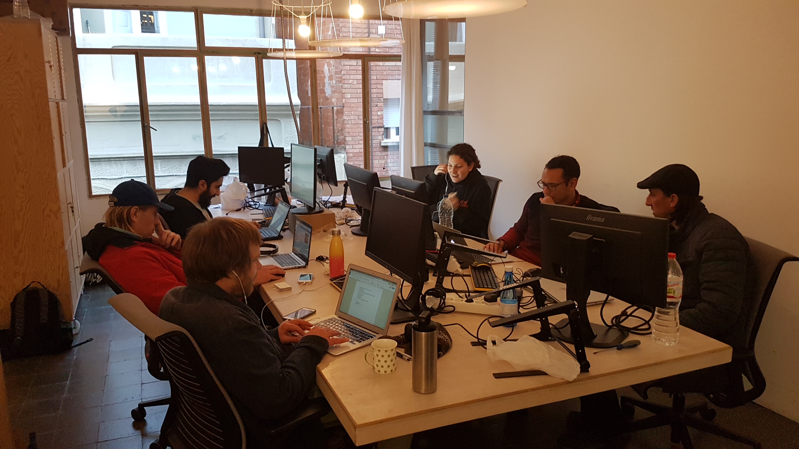 Early Hostaway employees working around a shared table of computers in 2018