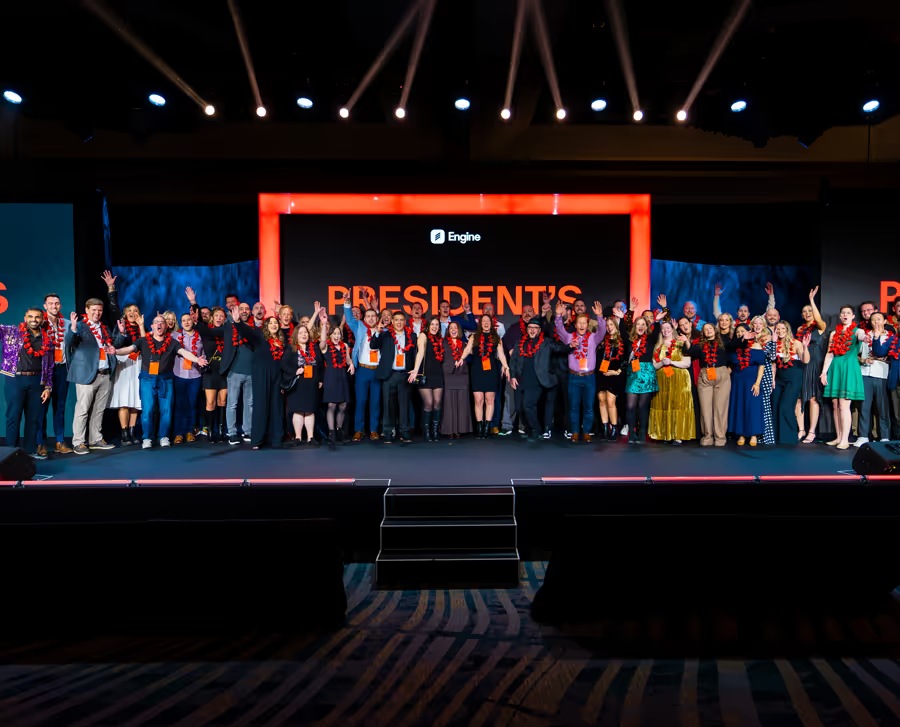 Engine team members gathered on stage at a company summit