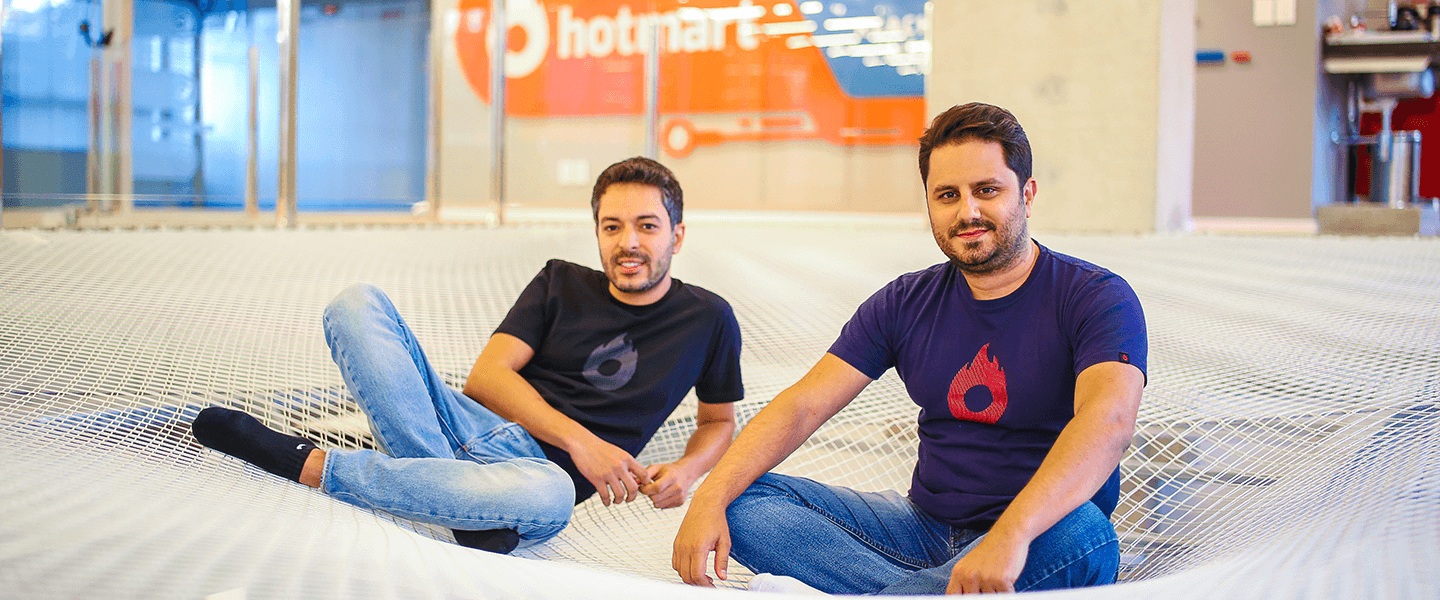 Hotmart cofounders Mateus Bicalho and João Pedro Resende together in an office