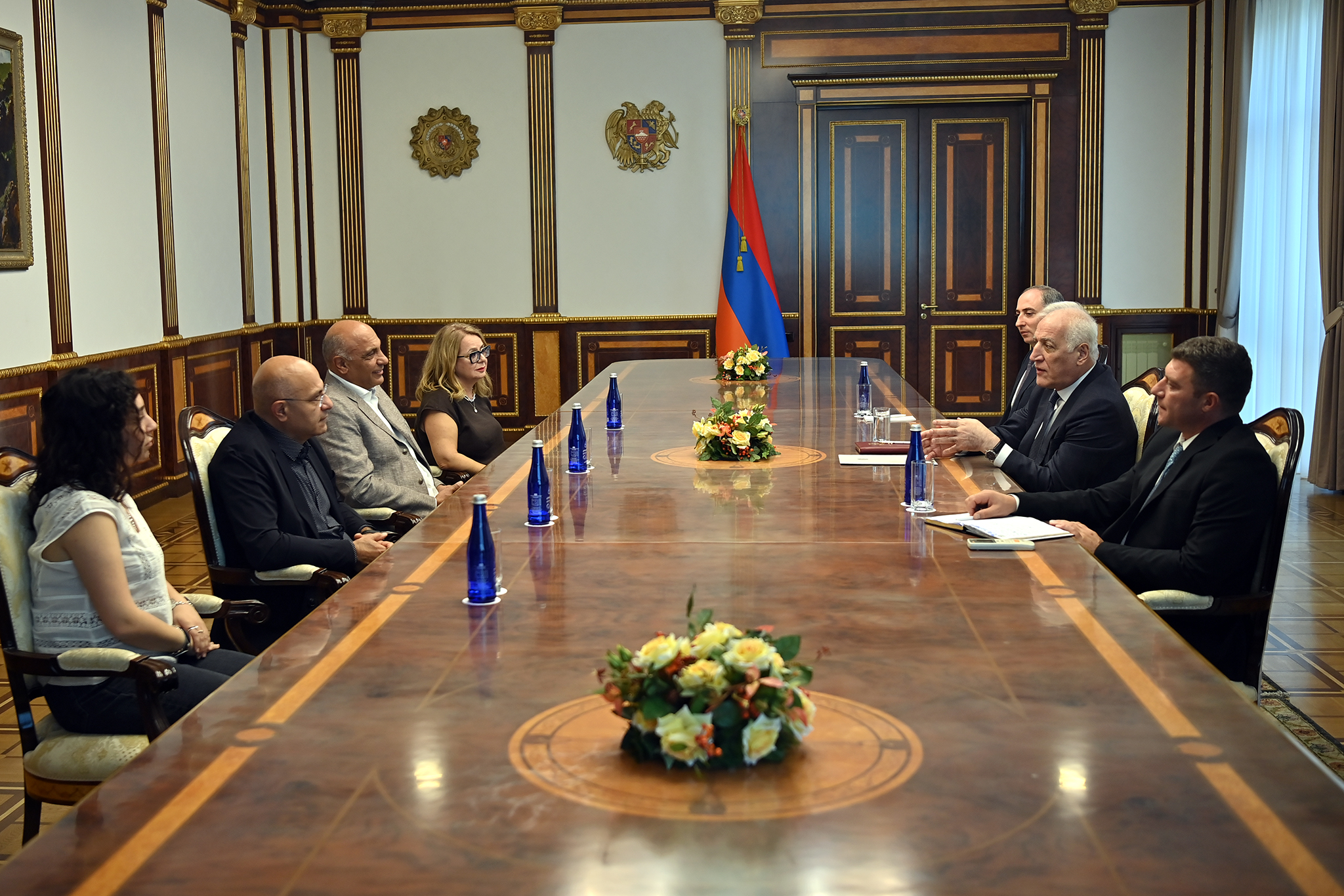 Avoyan and other guests seated across a meeting table from President Khachaturyan