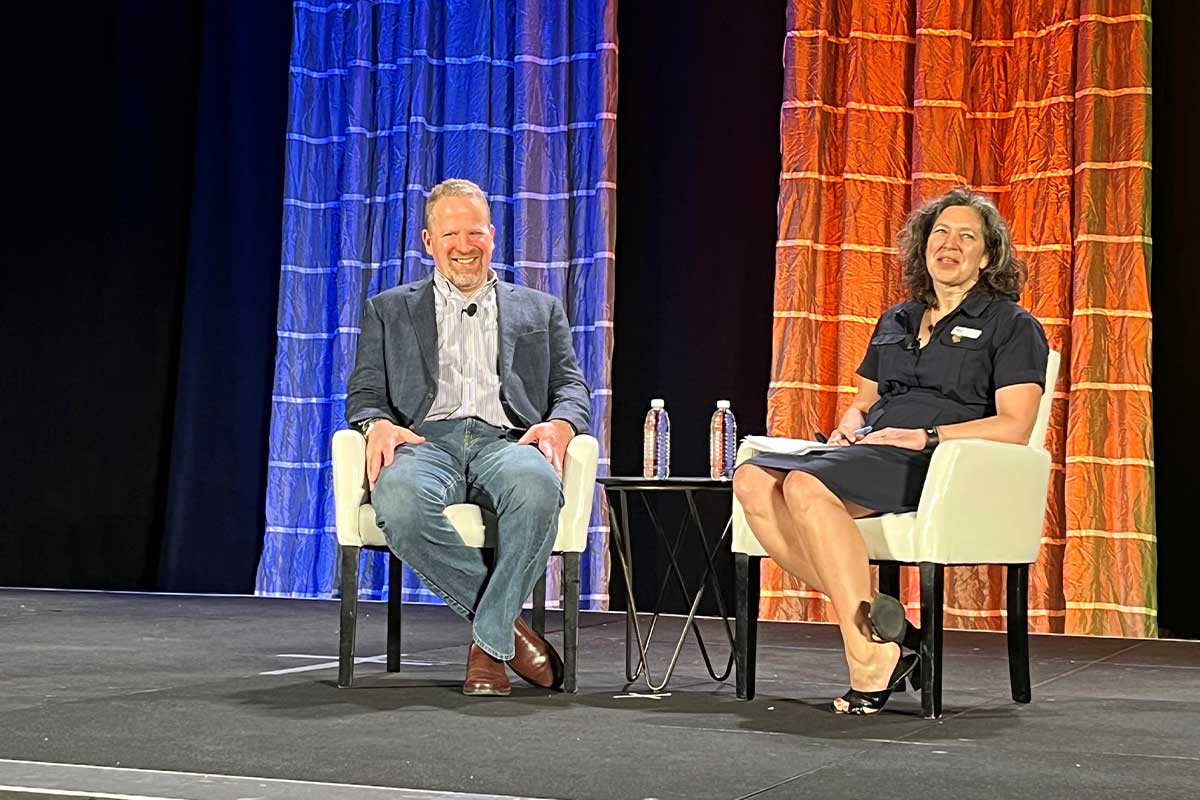 Howard Friedman and Christine Cochran seated on stage during their SNAXPO 2023 conversation