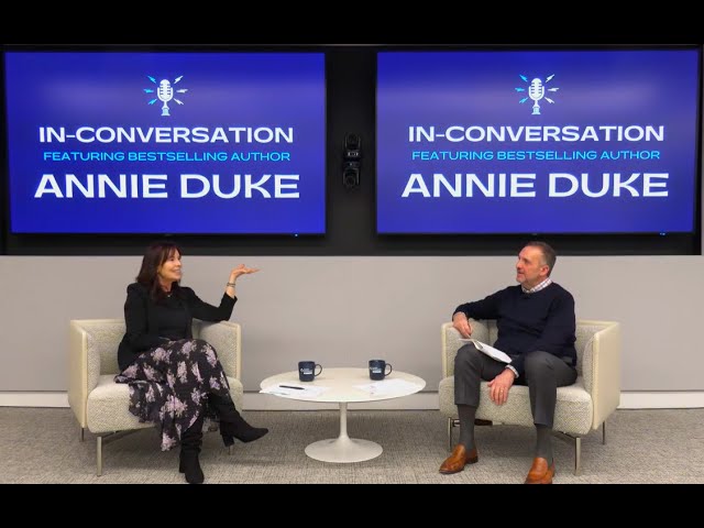 Annie Duke and Howard Schweitzer seated onstage during their In-Conversation discussion