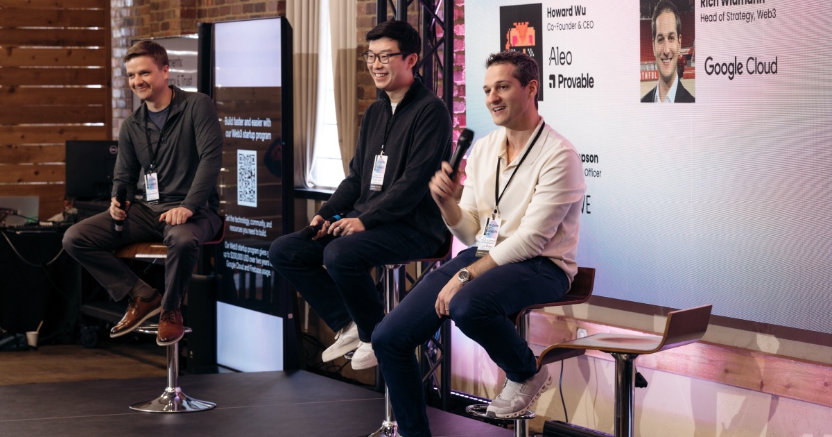 Howard Wu, seated in the center, smiles during a panel with Aleo, Provable and Google Cloud branding behind the speakers.