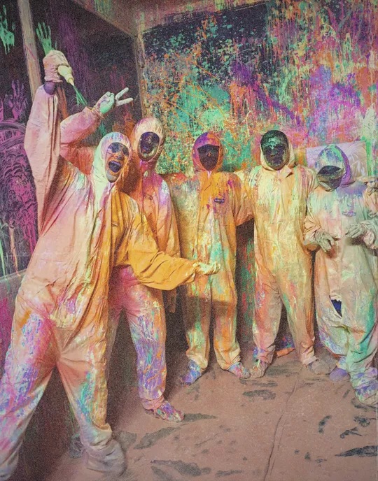Howdy teammates in protective suits at a colourful group activity