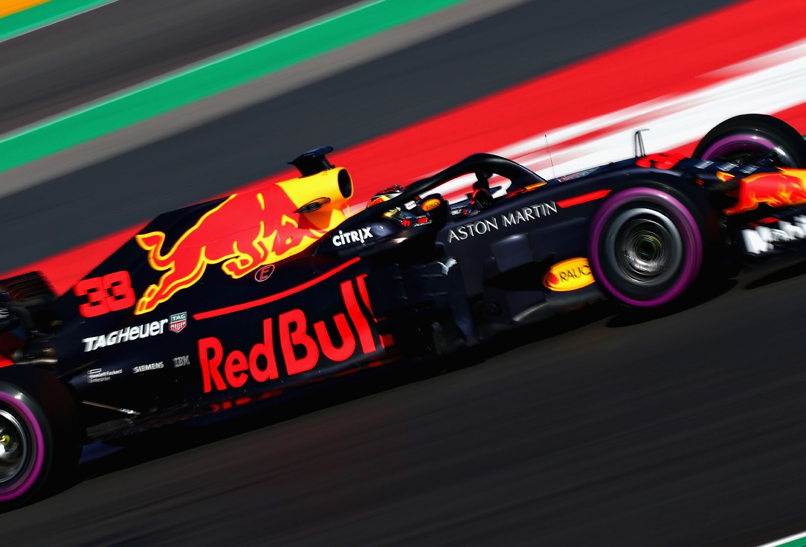 An Aston Martin Red Bull Racing car photographed at speed