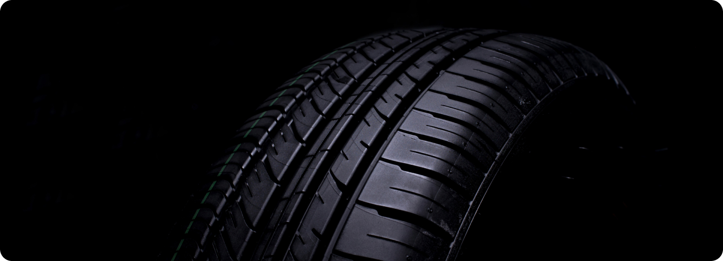 Close view of a tire tread against a black background