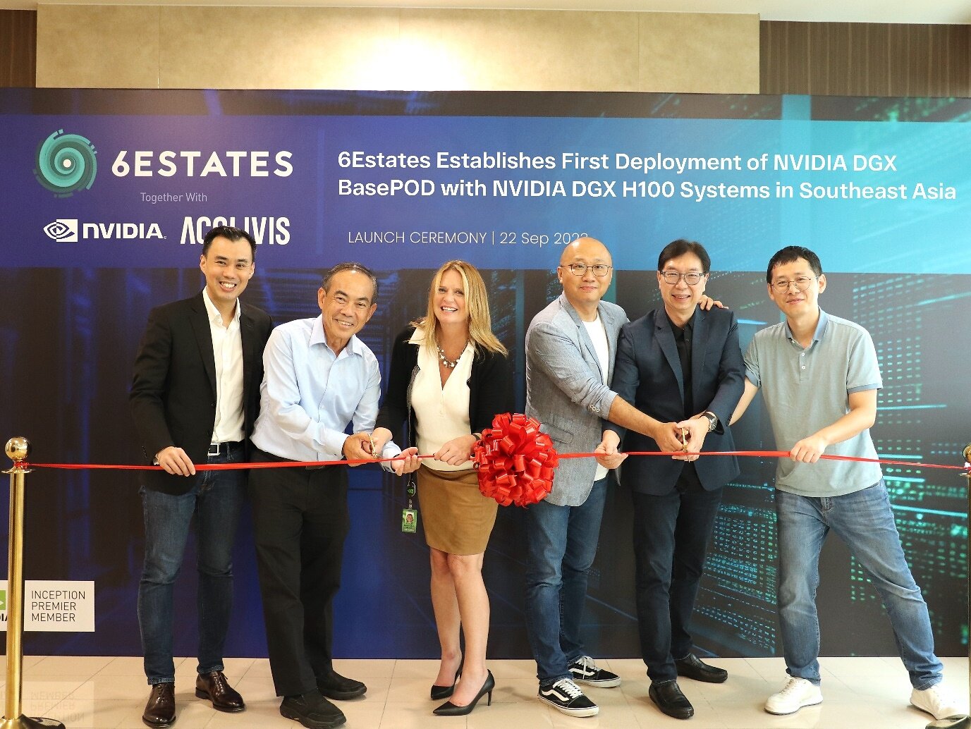 Six executives cutting a red ribbon at the 6Estates computing launch in September 2023