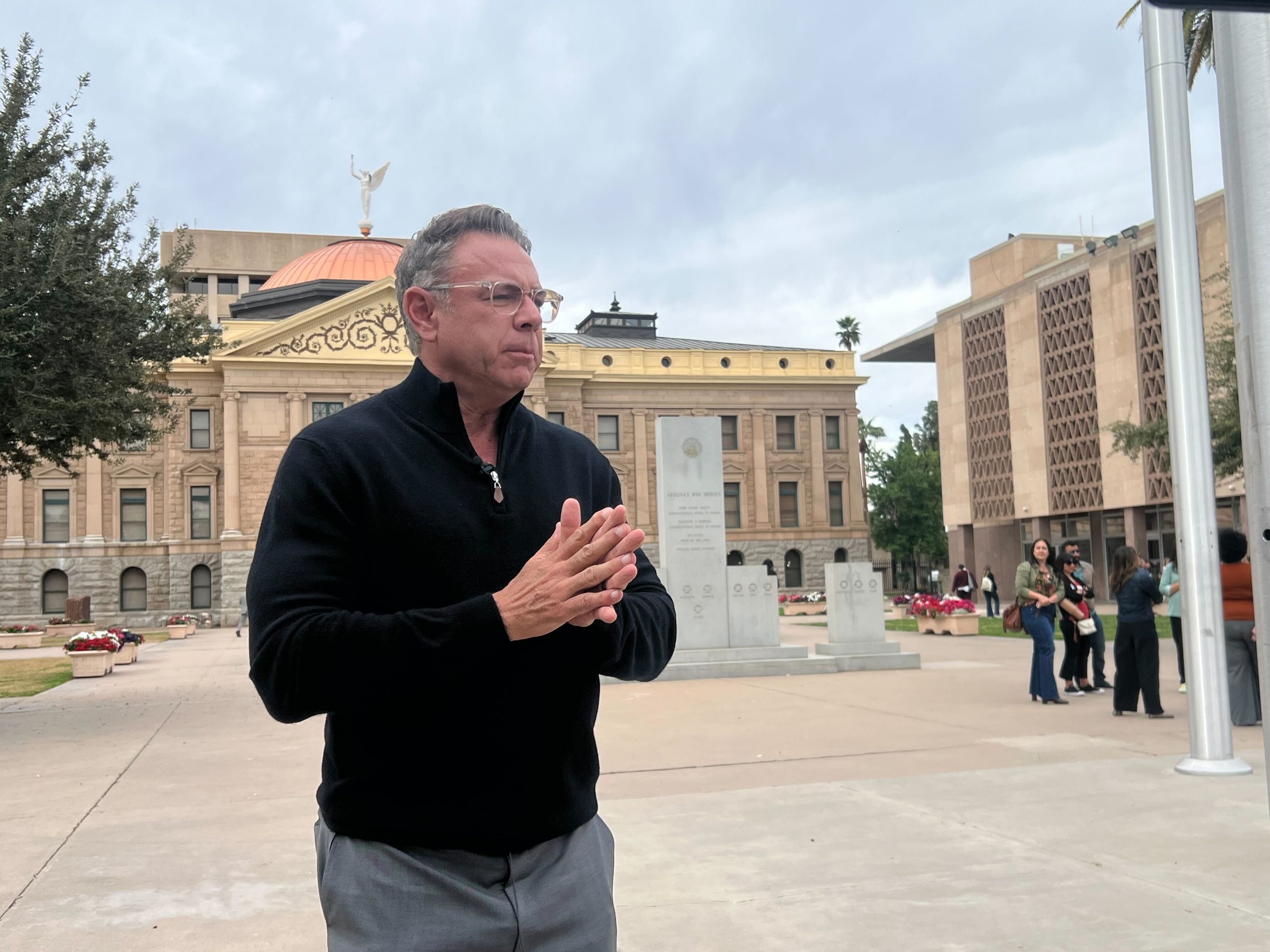 Hugh Lytle speaking outdoors in front of the Arizona State Capitol