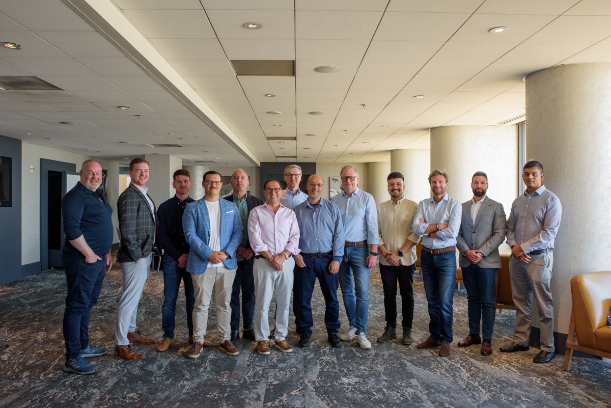Hugh Njemanze, near the center in a blue checked shirt, with colleagues at Anomali’s 2024 go-to-market gathering.