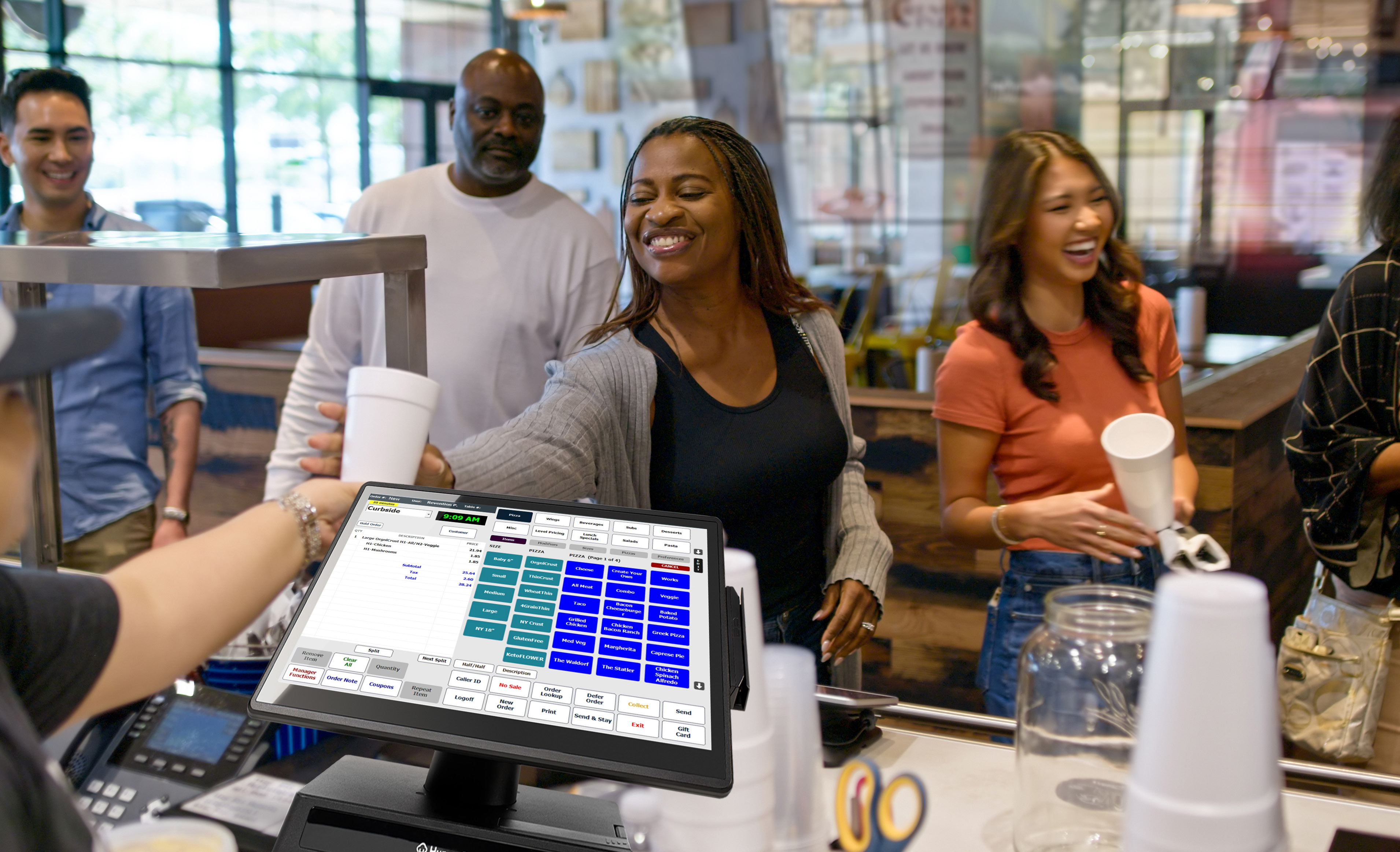 A restaurant counter with a HungerRush point-of-sale screen and guests waiting to order